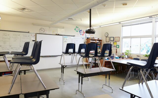 Empty classroom with chairs on tables